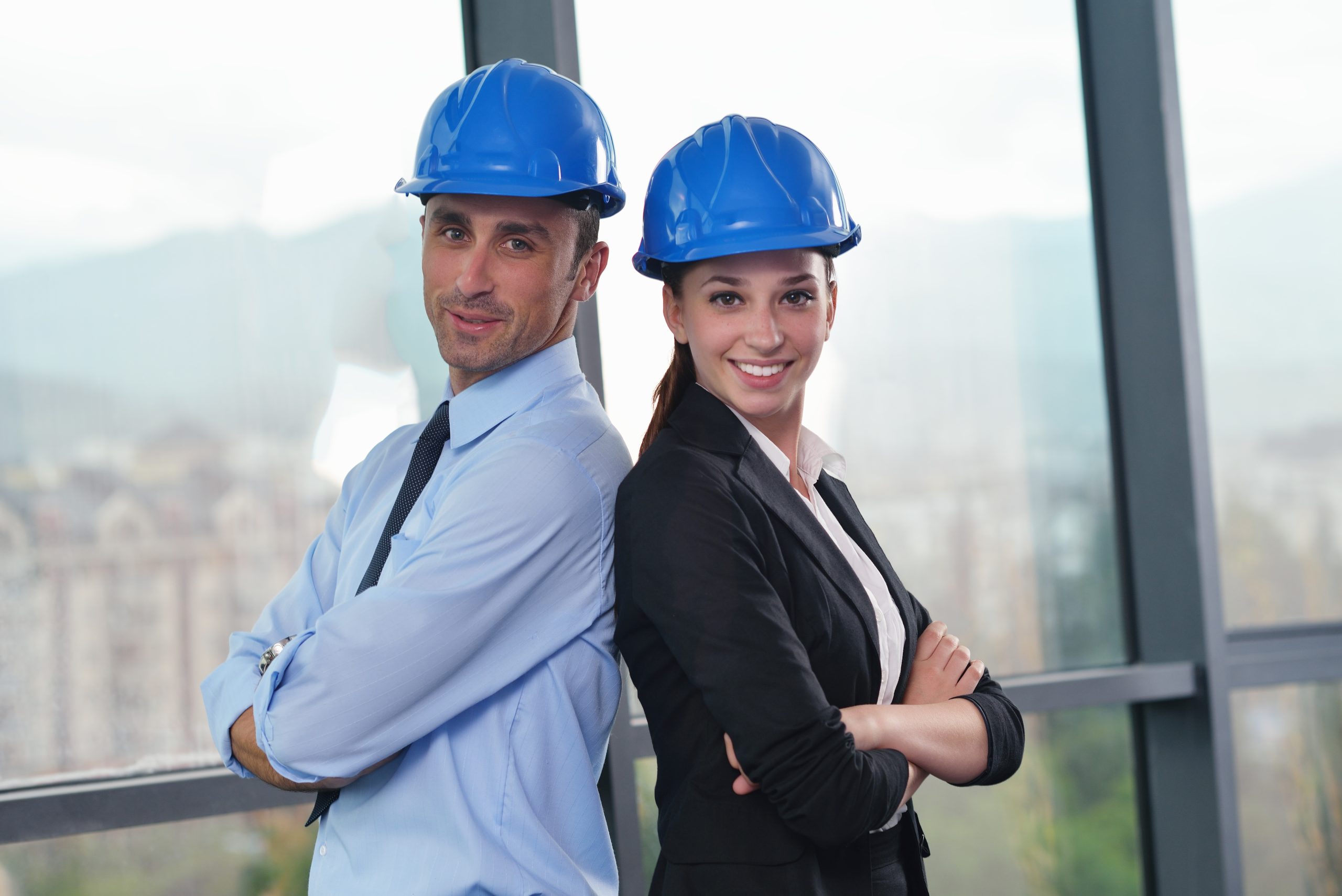 business people group on meeting and presentation  in bright modern office with construction engineer architect and worker looking building model and blueprint planbleprint plans