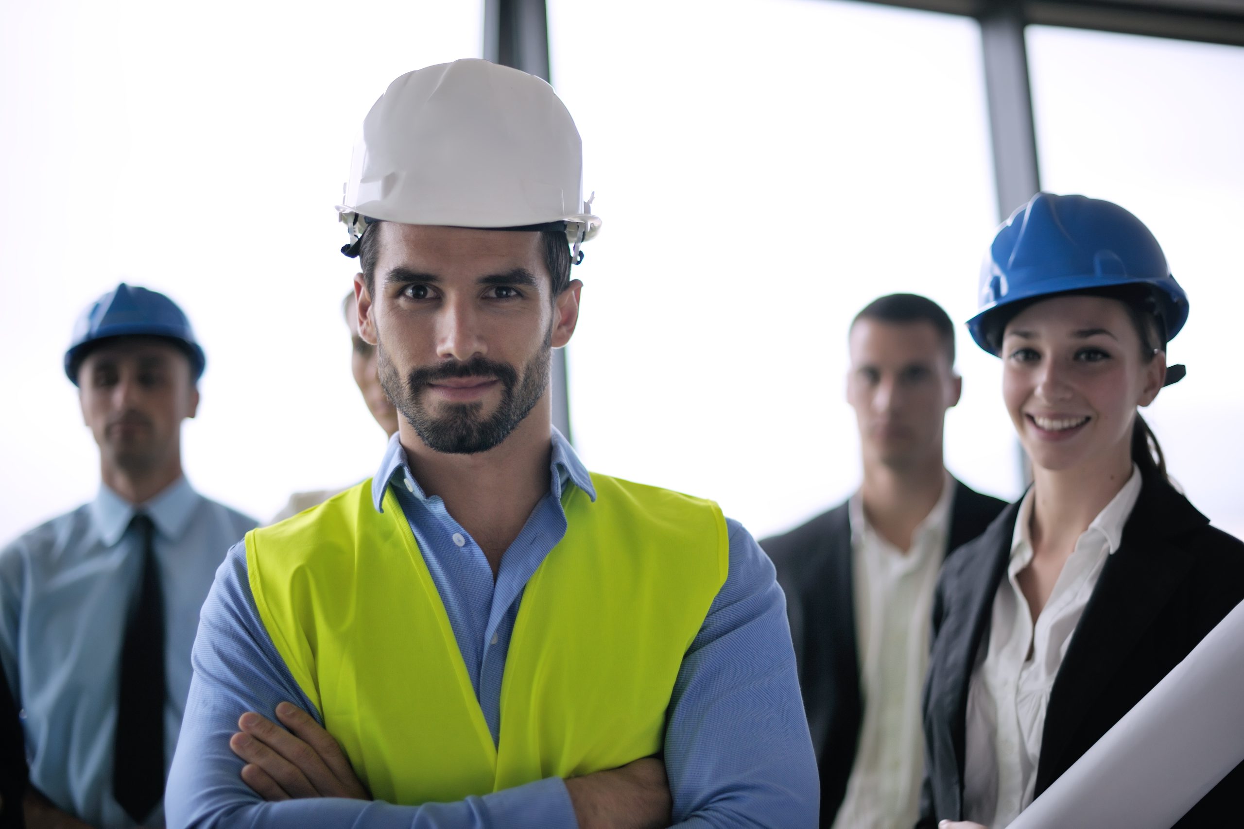 business people group on meeting and presentation  in bright modern office with construction engineer architect and worker looking building model and blueprint planbleprint plans